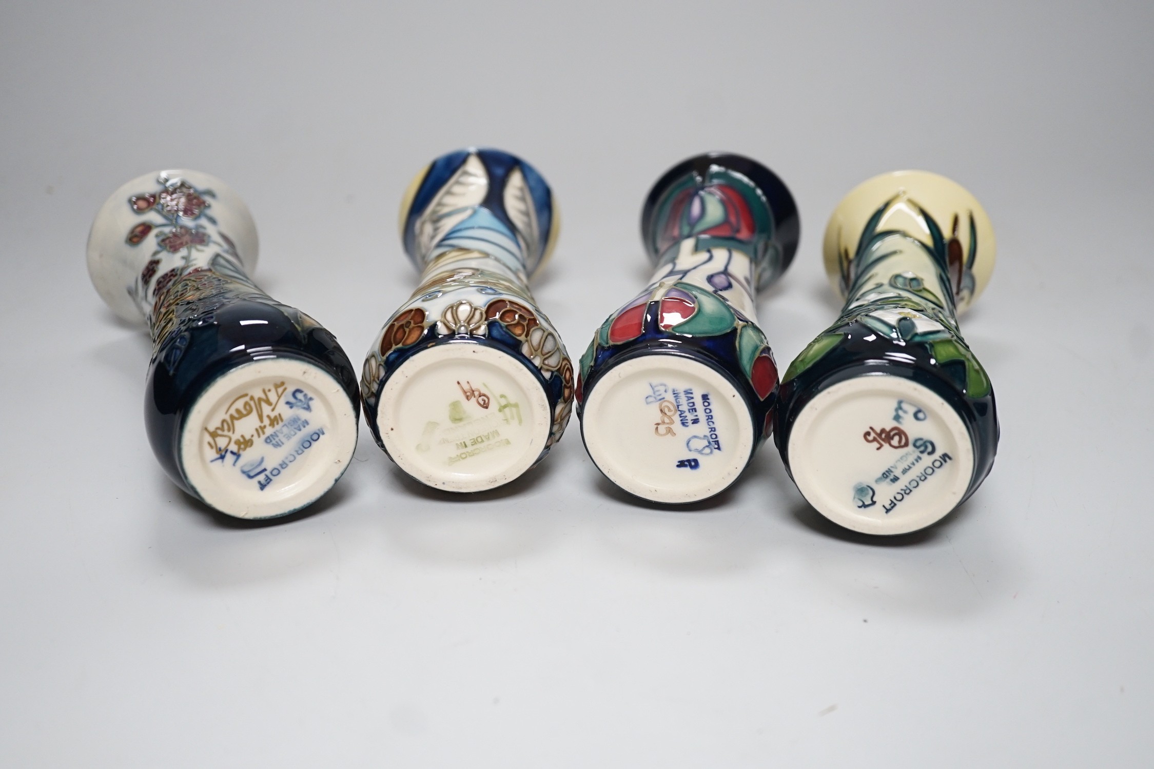 Four boxed small Moorcroft vases, Blackberry, Bulrush, Winds of Change, and a Rennie Macintosh Tribute. Each 11cm high